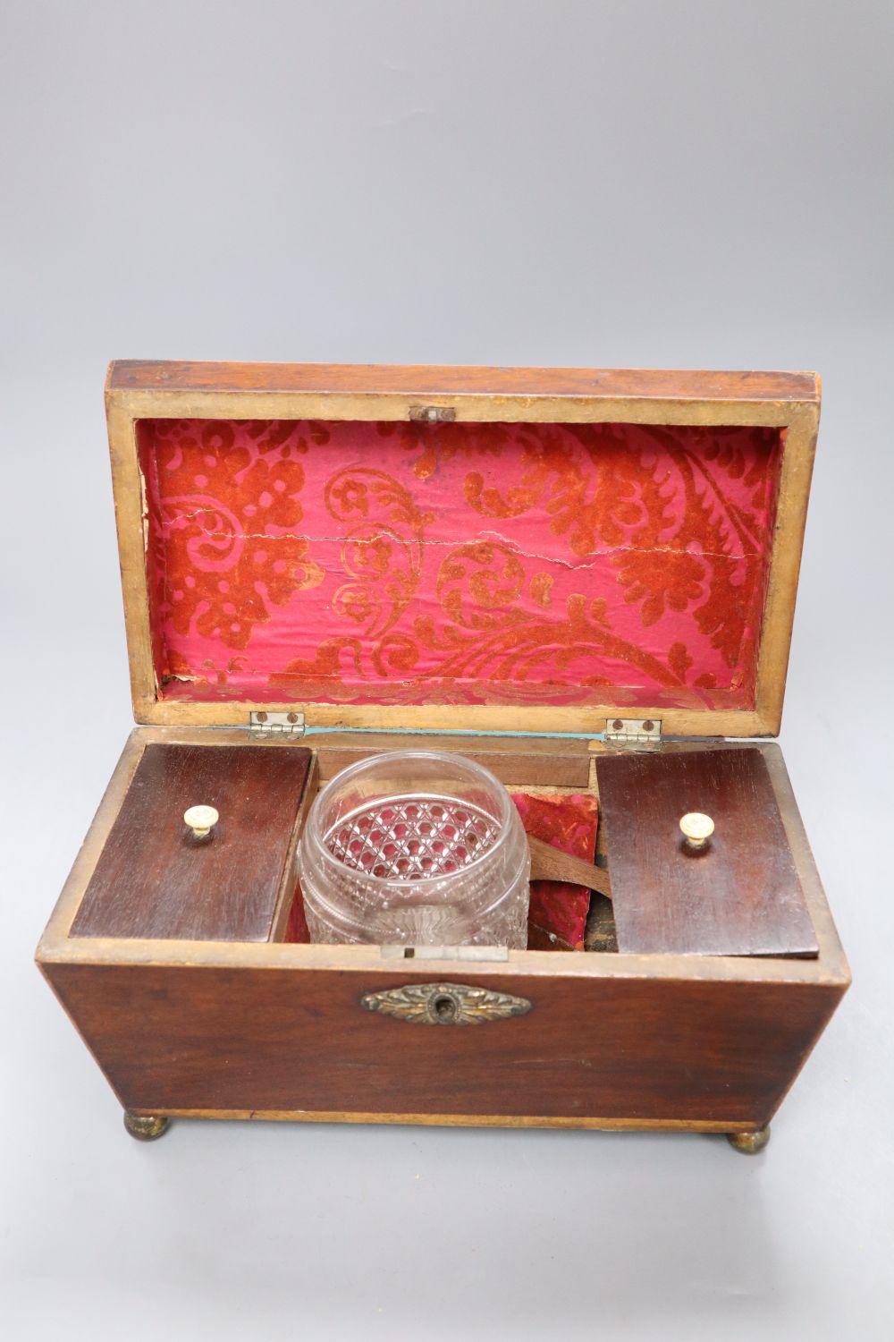 A Georgian mahogany tea caddy with associated mixing bowl and a similar writing slope, longest 35.5cm